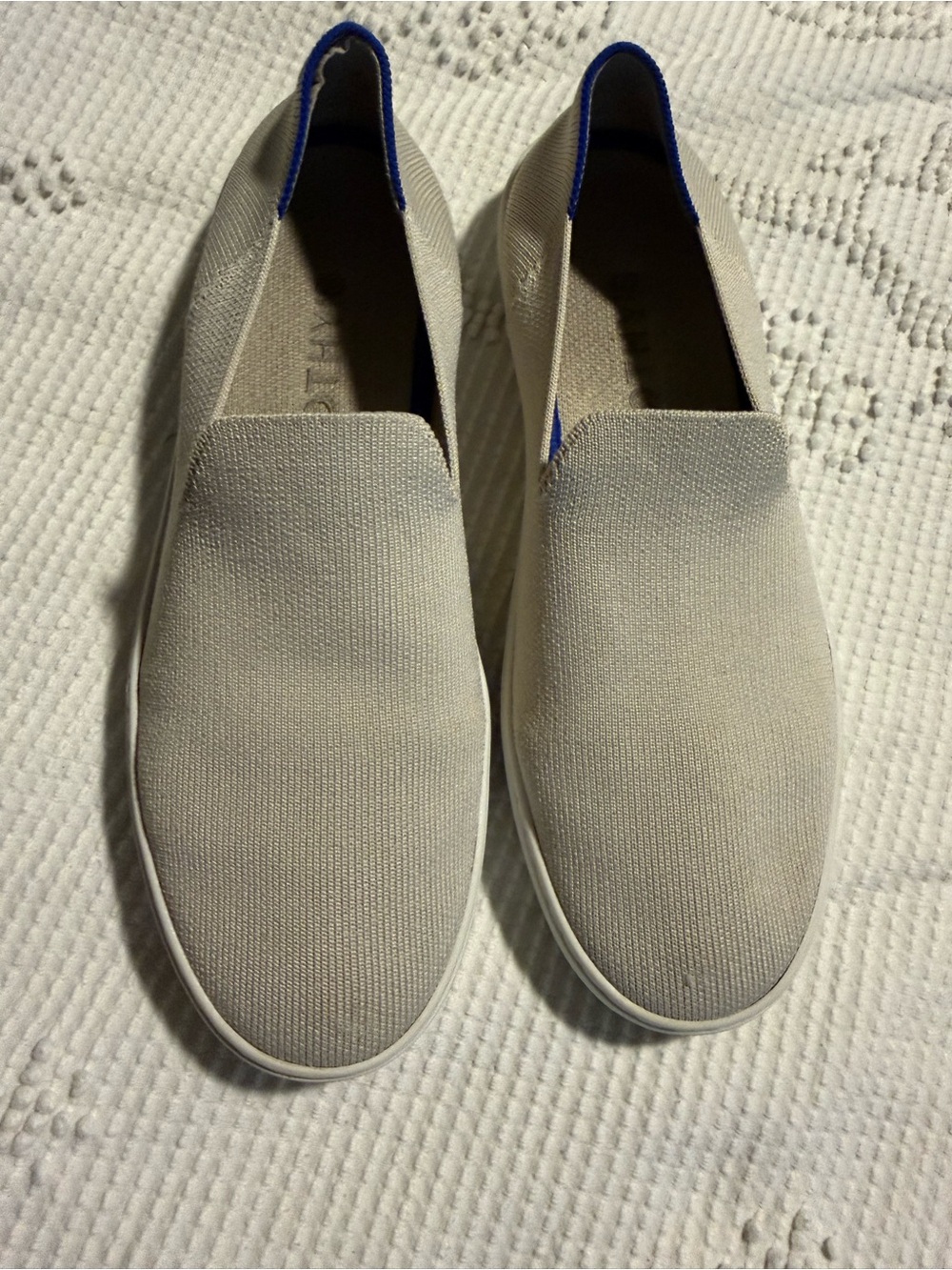 Rothy's Slip-On Sneakers in Light Gray with Blue Trim